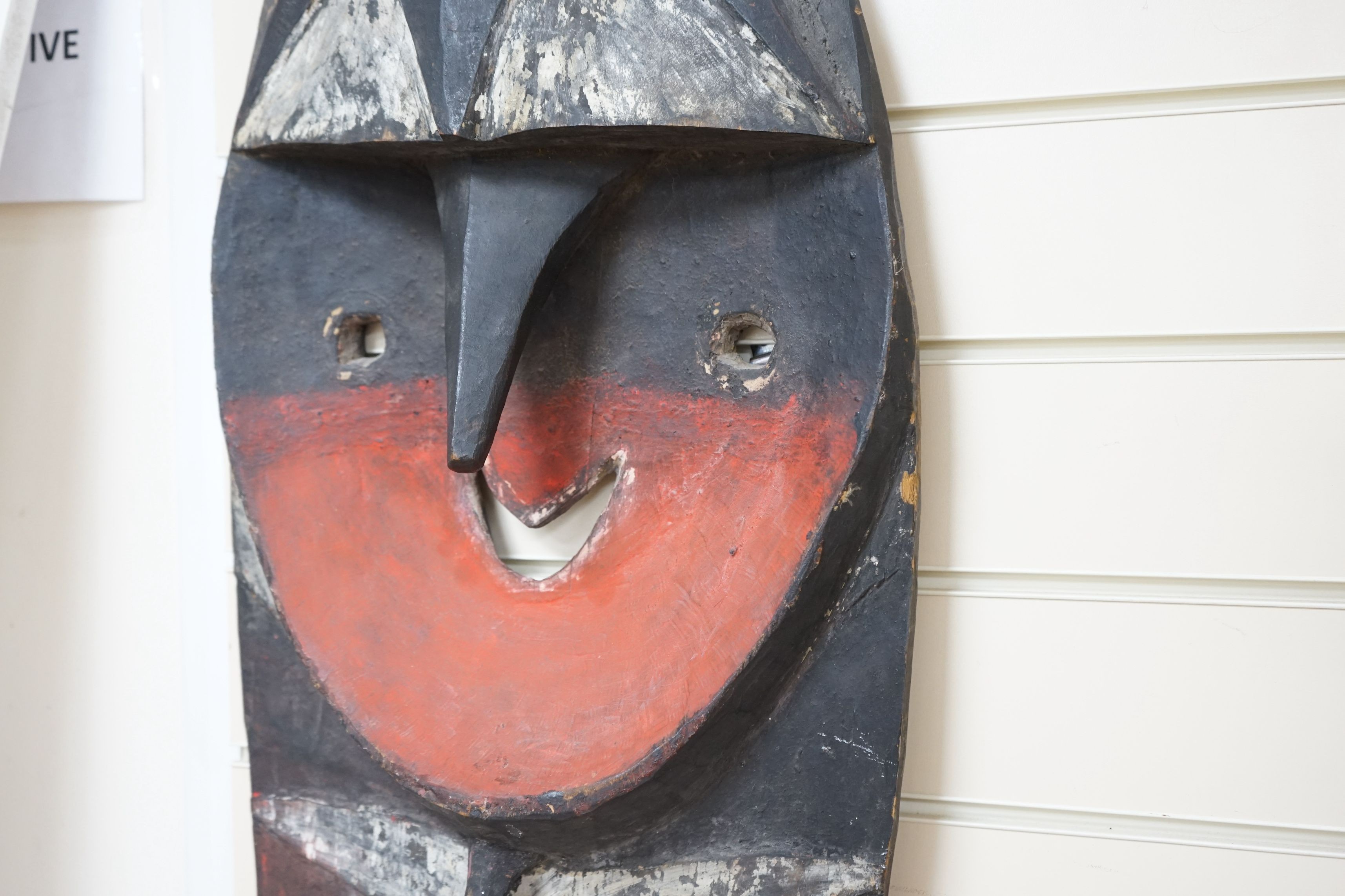 A Papua New Guinea Minja painted wood figure wall hanging in the form of a shield, 130cm tall